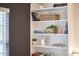 Bright white bookcase with decorative items and books, offering stylish storage and display at 1120 N Roxboro St, Durham, NC 27701