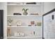 Stylish bookshelf with books, plants, clock and decor for a cozy home design at 1120 N Roxboro St, Durham, NC 27701