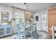 Sunlit dining room features a modern chandelier and stylish blue furniture set at 1120 N Roxboro St, Durham, NC 27701