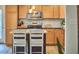 Modern kitchen featuring stainless steel appliances, light wood cabinets, and island with bar stool seating at 1120 N Roxboro St, Durham, NC 27701