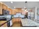 Well-equipped kitchen with stainless steel appliances, light wood cabinets, and a granite island provides ample space at 1120 N Roxboro St, Durham, NC 27701