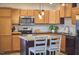 Beautiful kitchen features stainless steel appliances, light wood cabinets, and a granite island, ideal for cooking at 1120 N Roxboro St, Durham, NC 27701