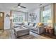 Comfortable living room with a large sectional sofa, stylish rug, and ample natural light, perfect for relaxing at 1120 N Roxboro St, Durham, NC 27701