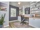 Home office featuring built-in shelving, cabinets, hardwood floors, and ample natural light at 1120 N Roxboro St, Durham, NC 27701