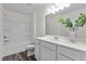 Clean bathroom featuring a tub-shower, white vanity with quartz countertop, and vinyl flooring at 1120 Tofino Dr, Durham, NC 27704
