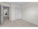 Empty, carpeted bedroom with a view to the next room at 1120 Tofino Dr, Durham, NC 27704