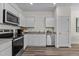 Well-equipped kitchen with stainless steel appliances, granite counters, and sleek cabinetry at 1120 Tofino Dr, Durham, NC 27704