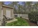 Charming backyard featuring a lounge chair on a patio, a white fence, and lush landscaping at 11251 Lofty Heights Pl, Raleigh, NC 27614