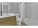 Well-lit bathroom featuring a single sink vanity and a tub with shower, offering a clean and functional space at 11251 Lofty Heights Pl, Raleigh, NC 27614