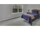 Neutrally decorated bedroom with a comfortable bed, large window, and neutral carpet at 11251 Lofty Heights Pl, Raleigh, NC 27614