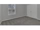 Neutral bedroom showcasing a window with shutters and a spacious closet providing ample storage and natural light at 11251 Lofty Heights Pl, Raleigh, NC 27614