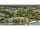 Aerial perspective featuring tennis courts, a playground, and a swimming pool, set within a lush residential community at 11251 Lofty Heights Pl, Raleigh, NC 27614