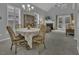 Cozy dining area with chandelier, fireplace view, and natural light from the windows at 11251 Lofty Heights Pl, Raleigh, NC 27614