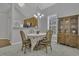 Bright dining area featuring hardwood floors, modern lighting, and stylish accents at 11251 Lofty Heights Pl, Raleigh, NC 27614