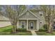 Inviting two-story home featuring a charming front porch with manicured landscaping at 11251 Lofty Heights Pl, Raleigh, NC 27614