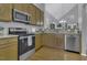 Stylish kitchen featuring granite countertops and stainless steel appliances at 11251 Lofty Heights Pl, Raleigh, NC 27614