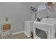Functional laundry room with washer, dryer, and storage shelves, creating a tidy and efficient space at 11251 Lofty Heights Pl, Raleigh, NC 27614