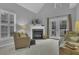 Bright living room with fireplace, vaulted ceilings, and French doors to the outside at 11251 Lofty Heights Pl, Raleigh, NC 27614