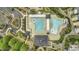 Aerial view of community pool with swimming lanes, leisure areas, and surrounding buildings, highlighting recreational amenities at 11251 Lofty Heights Pl, Raleigh, NC 27614