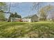 The home has a large, grassy backyard and a wood deck next to the house and the detached garage at 114 Marshay Meadow Rd, Youngsville, NC 27596