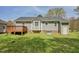 This backyard features a wood deck, a brick foundation, and green grass at 114 Marshay Meadow Rd, Youngsville, NC 27596