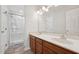 Bright bathroom featuring a double sink vanity and a glass enclosed shower stall at 114 Marshay Meadow Rd, Youngsville, NC 27596