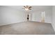 Large bedroom with a ceiling fan, multiple doorways, and neutral carpet at 114 Marshay Meadow Rd, Youngsville, NC 27596