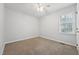 Neutral bedroom with an overhead fan, plush carpet, and a view from the bright window at 114 Marshay Meadow Rd, Youngsville, NC 27596