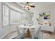 Bright dining area featuring a bay window, ceiling fan, and modern decor at 114 Marshay Meadow Rd, Youngsville, NC 27596