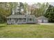 Charming single-story home with a welcoming front porch, detached two-car garage, and well-manicured lawn at 114 Marshay Meadow Rd, Youngsville, NC 27596