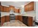 Functional kitchen with wooden cabinets, black appliances, and ample counter space at 114 Marshay Meadow Rd, Youngsville, NC 27596
