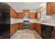 Well-lit kitchen with wooden cabinets, stainless steel appliances, and neutral countertops at 114 Marshay Meadow Rd, Youngsville, NC 27596