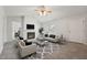 Bright living room with a fireplace, plush carpet, and a ceiling fan; perfect for relaxing or entertaining at 114 Marshay Meadow Rd, Youngsville, NC 27596