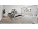 Spacious primary bedroom with a ceiling fan, large window, and neutral carpet at 114 Marshay Meadow Rd, Youngsville, NC 27596