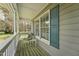 Cozy porch with wood flooring, comfortable seating, and views of the surrounding landscape through bright windows at 114 Marshay Meadow Rd, Youngsville, NC 27596