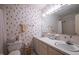 Neutral bathroom with double sink vanity, decorative wallpaper, and ample lighting at 114 Montrose Dr # 114, Durham, NC 27707