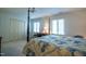 Bright bedroom features a four-poster bed, a desk, and two large windows with blinds at 114 Montrose Dr # 114, Durham, NC 27707