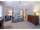 Spacious bedroom features a four-poster bed, a sitting area, and a wooden dresser with a lamp at 114 Montrose Dr # 114, Durham, NC 27707