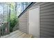 View of exterior shed with door, wooden deck, horizontal siding, and greenery in the background at 114 Montrose Dr # 114, Durham, NC 27707