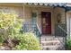 Close-up of front entrance with brick steps, railing, and landscaped garden at 114 Montrose Dr # 114, Durham, NC 27707
