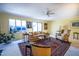 Spacious living room featuring large windows, comfortable seating, area rug, and decorative plants at 114 Montrose Dr # 114, Durham, NC 27707