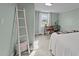 Bedroom featuring light green walls, neutral carpet, and built-in desk by window at 116 Lakewood Dr, Wendell, NC 27591