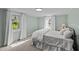Comfortable bedroom features neutral carpet, light green walls, and natural light from windows at 116 Lakewood Dr, Wendell, NC 27591