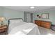 Bedroom with light green walls, neutral carpet, and wooden dresser at 116 Lakewood Dr, Wendell, NC 27591