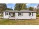 Charming home with inviting front porch, neatly painted brick and dark shutters at 116 Lakewood Dr, Wendell, NC 27591