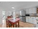 Bright kitchen with white cabinets, stainless steel refrigerator, and casual dining at 116 Lakewood Dr, Wendell, NC 27591