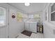 Well-lit laundry room with washer, dryer, and water heater, enhanced by multiple windows at 116 Lakewood Dr, Wendell, NC 27591