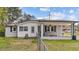 Quaint home with a covered patio, fenced yard, and gray brick accents at 116 Lakewood Dr, Wendell, NC 27591