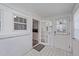 Bright sunroom with white brick accents, checkered floor, and views of the kitchen at 116 Lakewood Dr, Wendell, NC 27591
