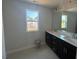 Bathroom with double sink vanity with dark cabinets and bright window at 118 Fairwinds Drive Dr, Lillington, NC 27546